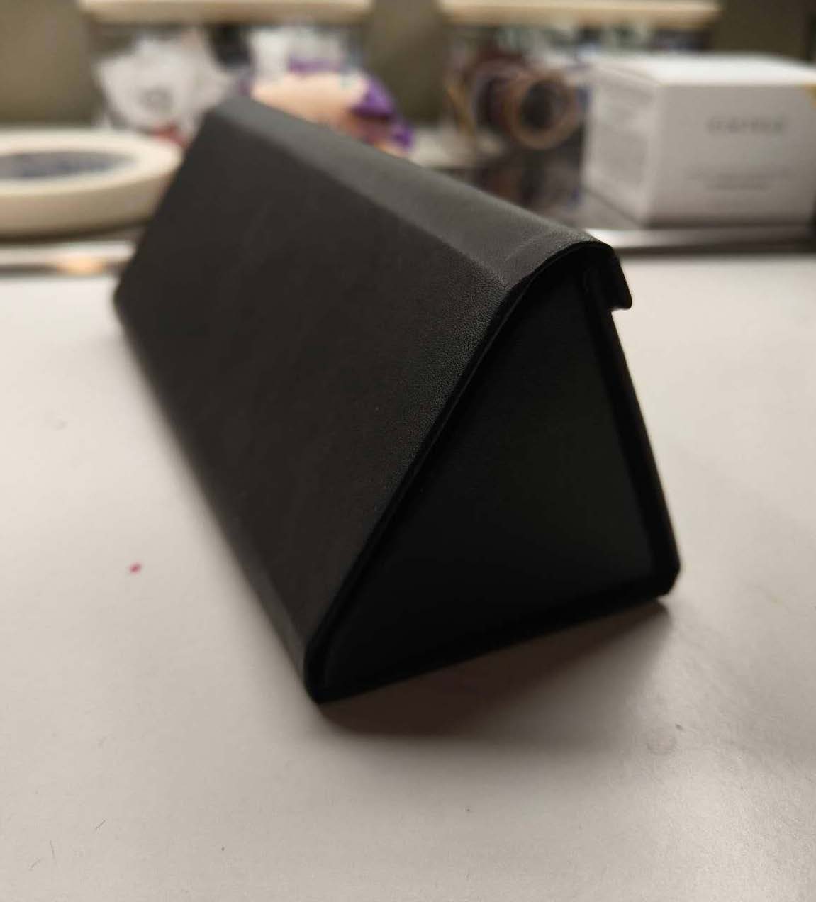 This is a 3/4 side shot image of a glasses container